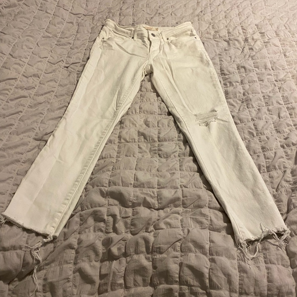 Distressed white Levi jeans